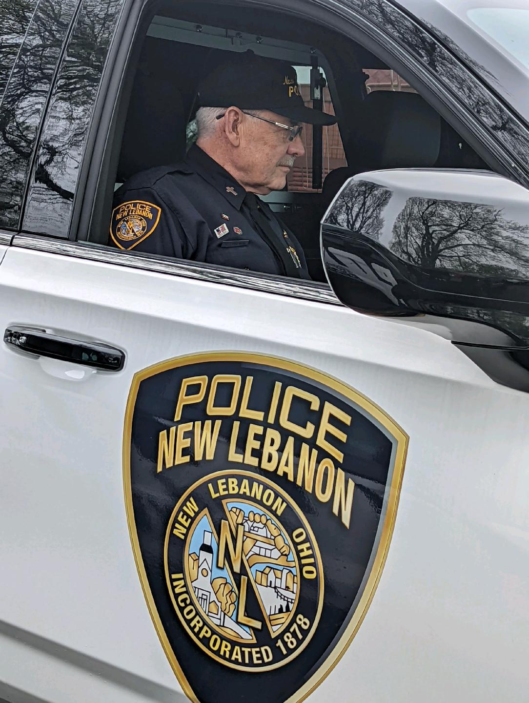 Laird Baldwin sits inside of a squad car