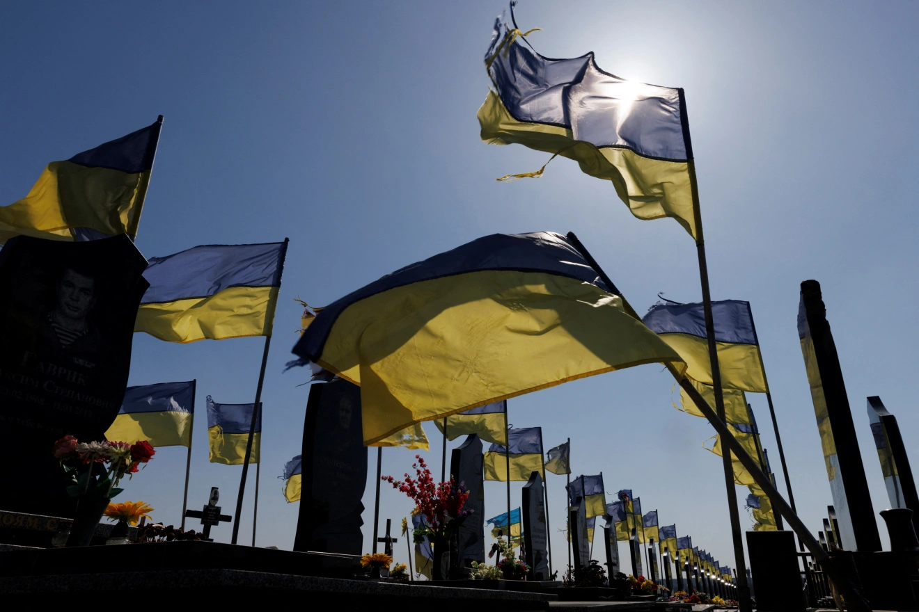 Ukrainian flags adorn a cemetery  