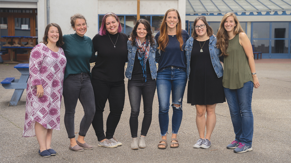 The group of women smile