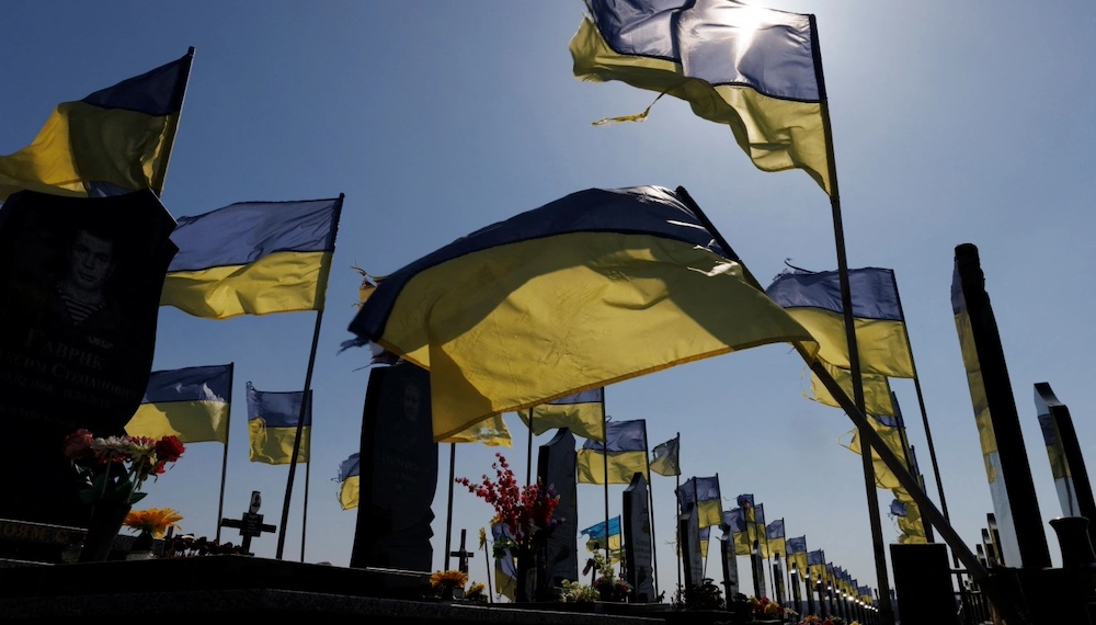 Ukrainian flags adorn a cemetery