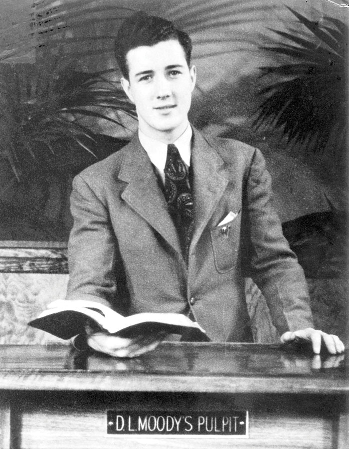 A Young George Sweeting stands in Moody's pulpit
