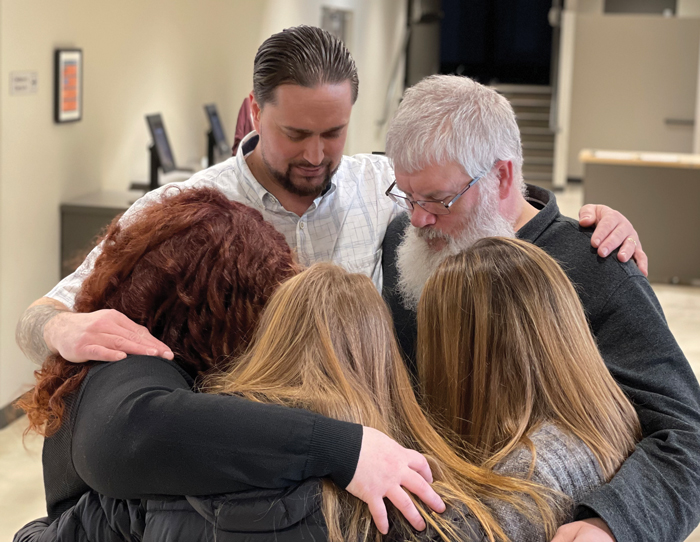 Adrian huddles in prayer with members of Creekside Church in Wasilla, Alaska, where he is a youth pastor.